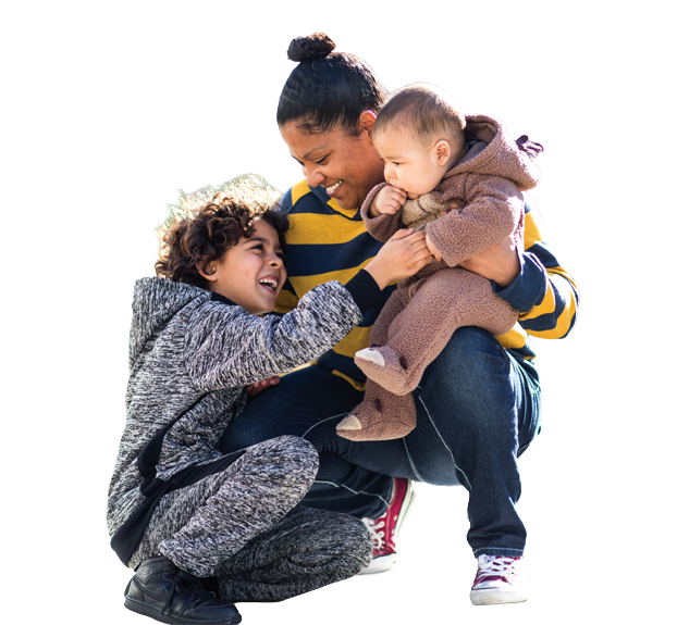 A mother and daughter embracing and smiling at each other outside their home