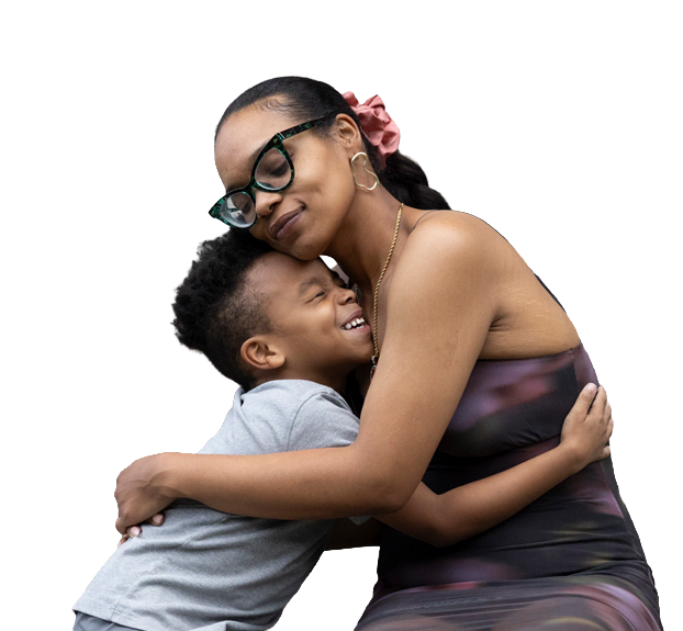A mother and daughter embracing and smiling at each other outside their home